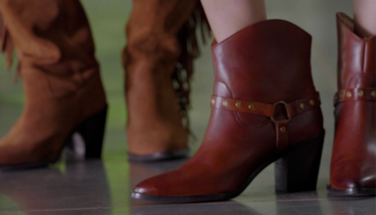 Woman styling tan boots with autumn outfit from Westside