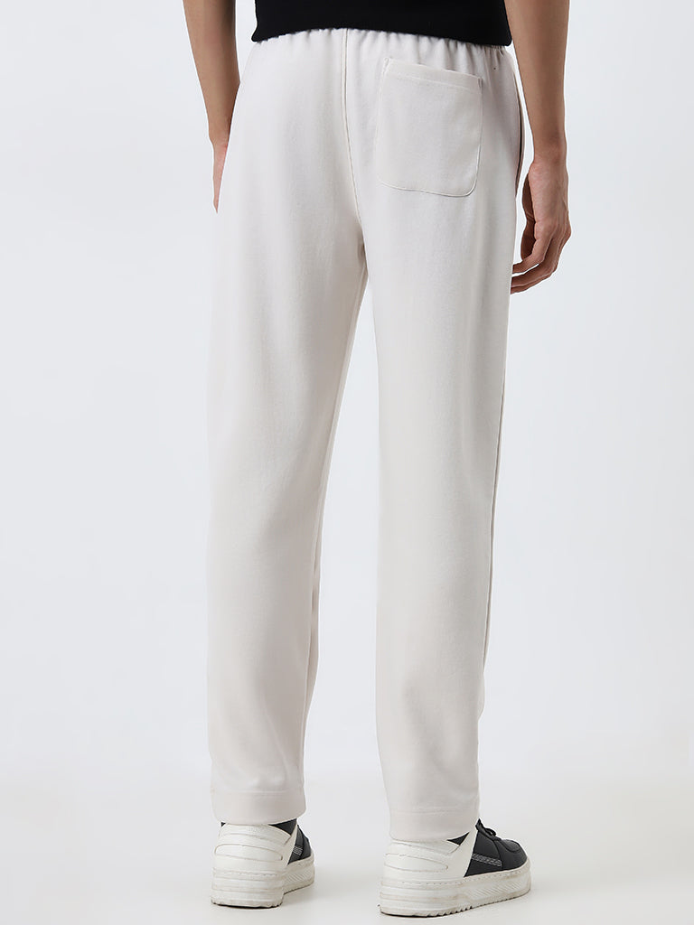 Westside Studiofit Men's Off-White Solid Relaxed-Fit Mid-Rise Track Pants for Sports Wear Back View
