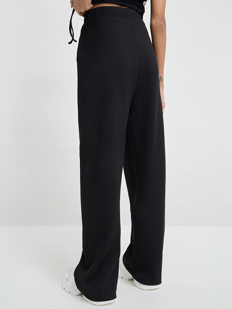 Westside Studiofit Women's Black Ribbed High-Rise Track Pants for Sports Wear Back View