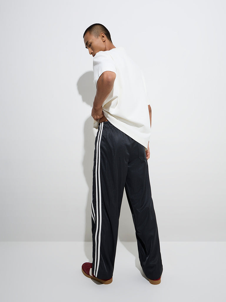 Westside Nuon Men's Black Striped Relaxed-Fit Mid-Rise Track Pants for Casual Wear Back View