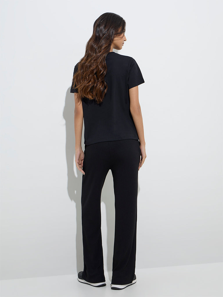 Westside Studiofit Women's Black Ribbed-Textured High-Rise Track Pants for Sports Wear Back View