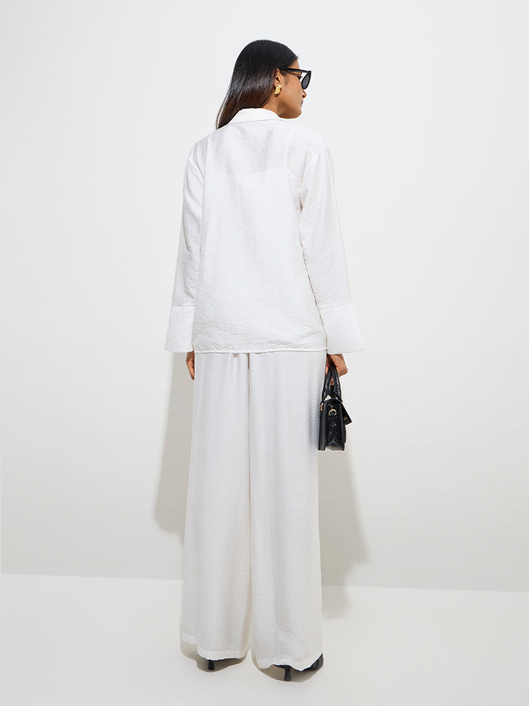 westisde Wardrobe Women's Ivory Crinkle-Textured Flared Mid-Rise Pants for Work Wear Back View