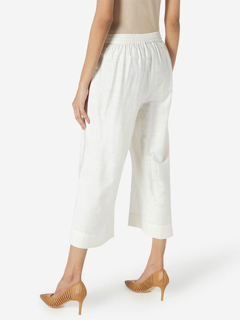 Zuba Off White Slim Fit Cropped Palazzos | Off White Slim Fit Cropped Palazzos for women back view - Westside