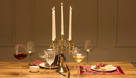 Christmas table styled with candles, tableware and festive décor for a warm holiday setting