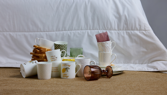 Festive home décor collection from Westside featuring dinnerware, candles, and cushions