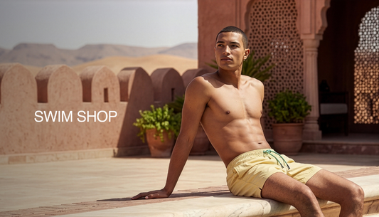 Men wearing stylish swim shorts and summer essentials by the poolside