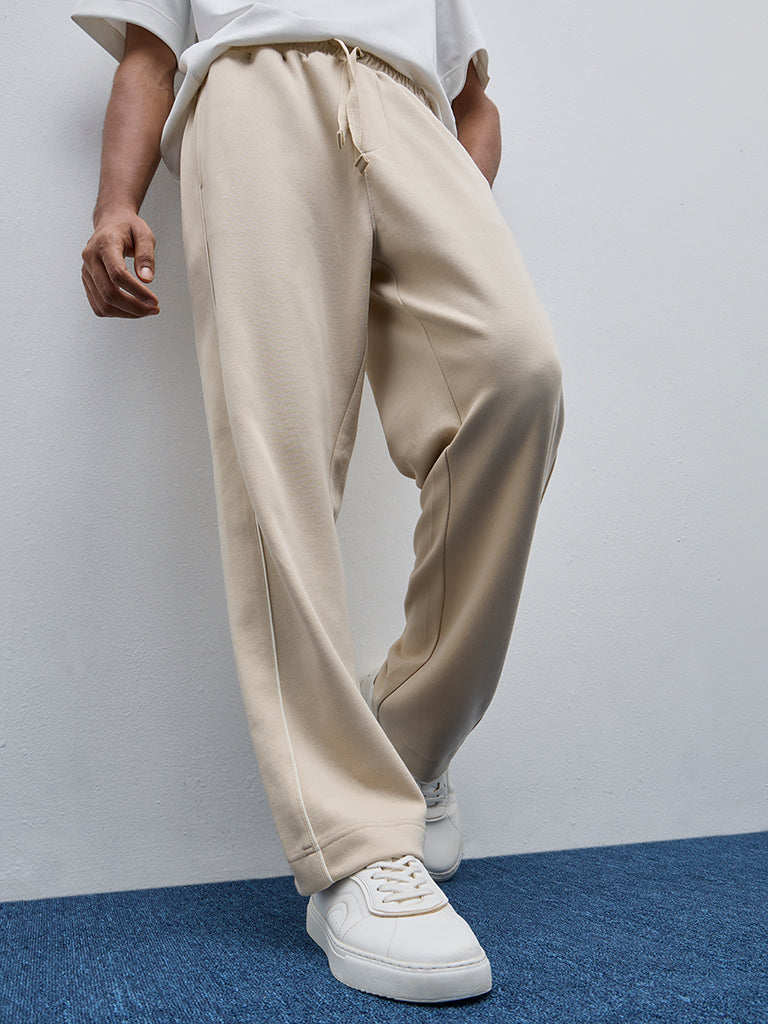 Westside Studiofit Men's Beige Relaxed-Fit Mid-Rise Cotton-Blend Track Pants for Sports Wear Front view