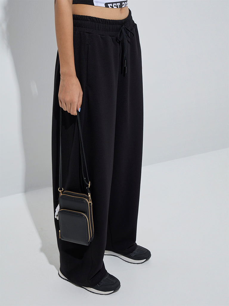 Westside Studiofit Women's Black Solid High-Rise Cotton Track Pants for Sports Wear Front View