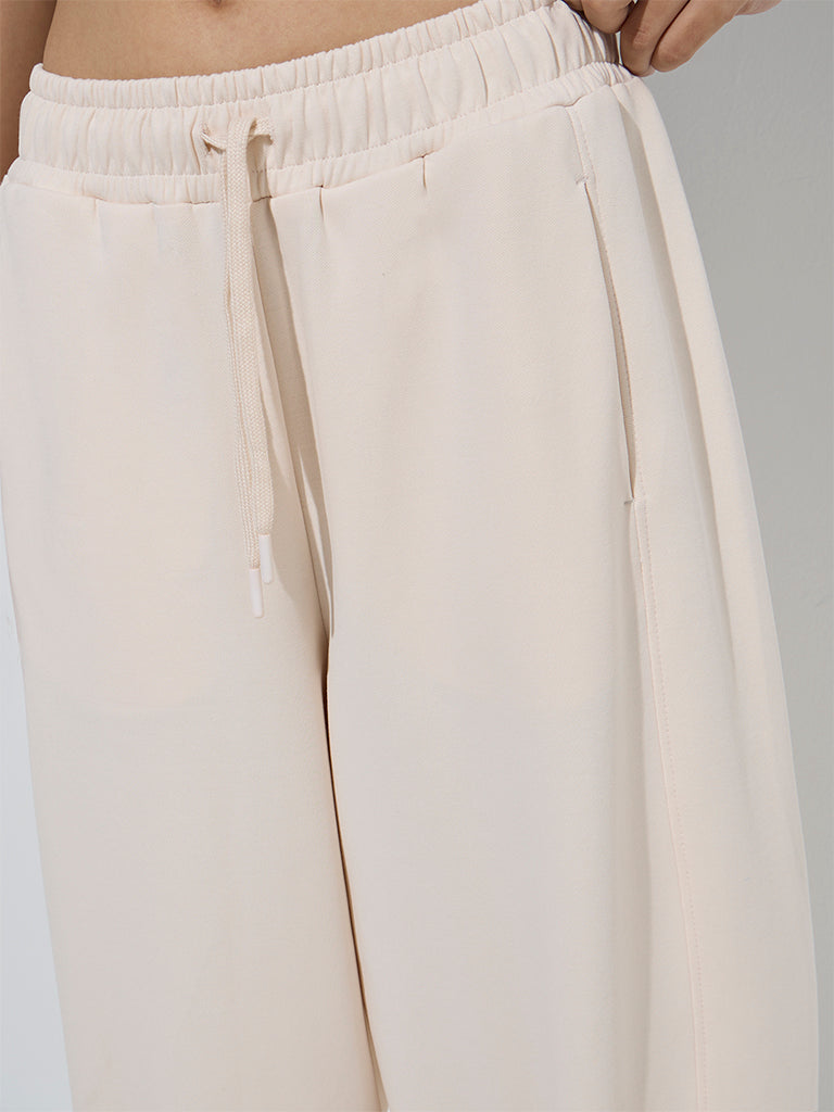 Westside Studiofit Women's Beige Solid High-Rise Cotton Track Pants for Sports Wear Zoom View