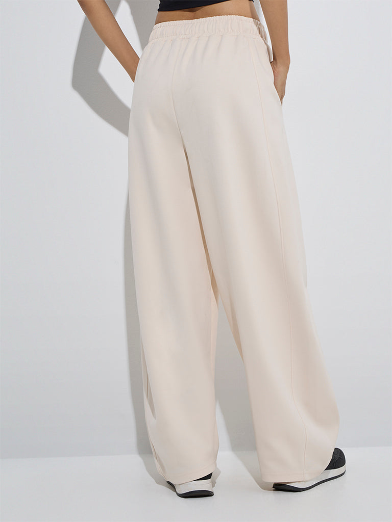 Westside Studiofit Women's Beige Solid High-Rise Cotton Track Pants for Sports Wear Back View