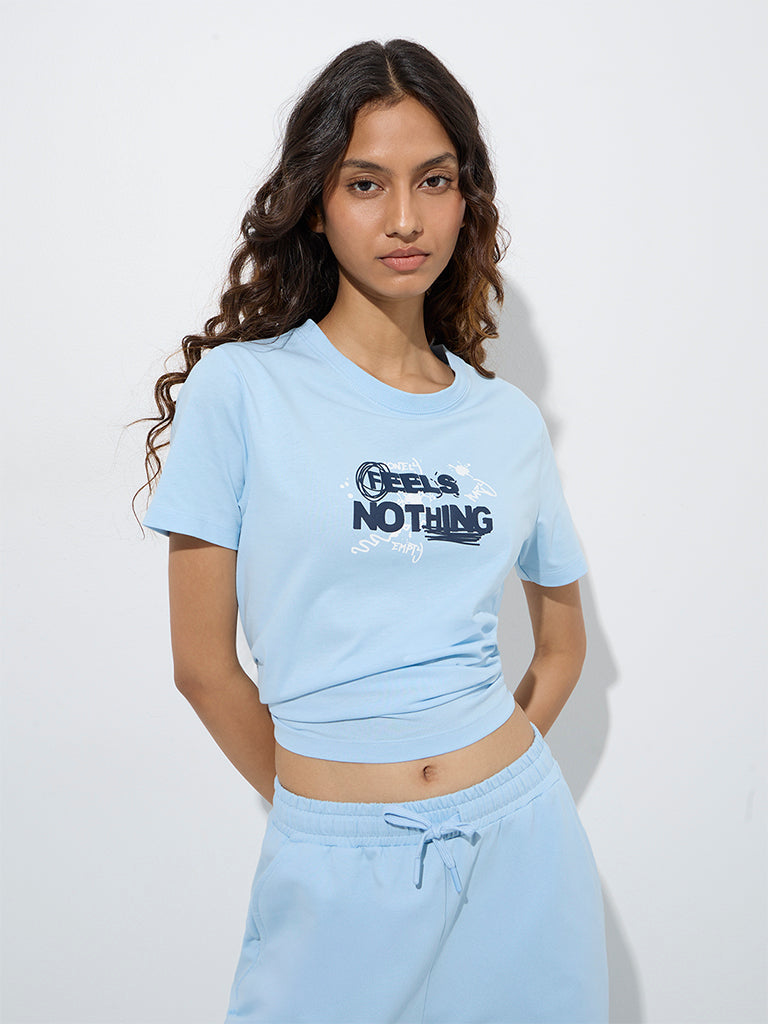 Westside Studiofit Women's Light Blue Typographic Cotton T-Shirt for Sports Wear Front View