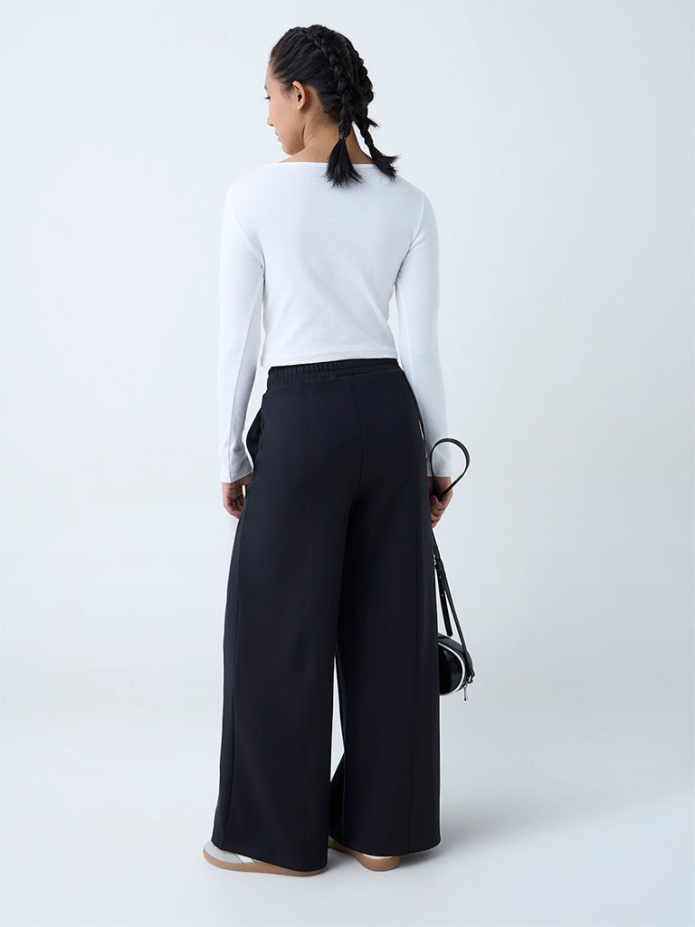 Westside Studiofit Women's Black Solid High-Rise Track Pants for Sports Wear Back View