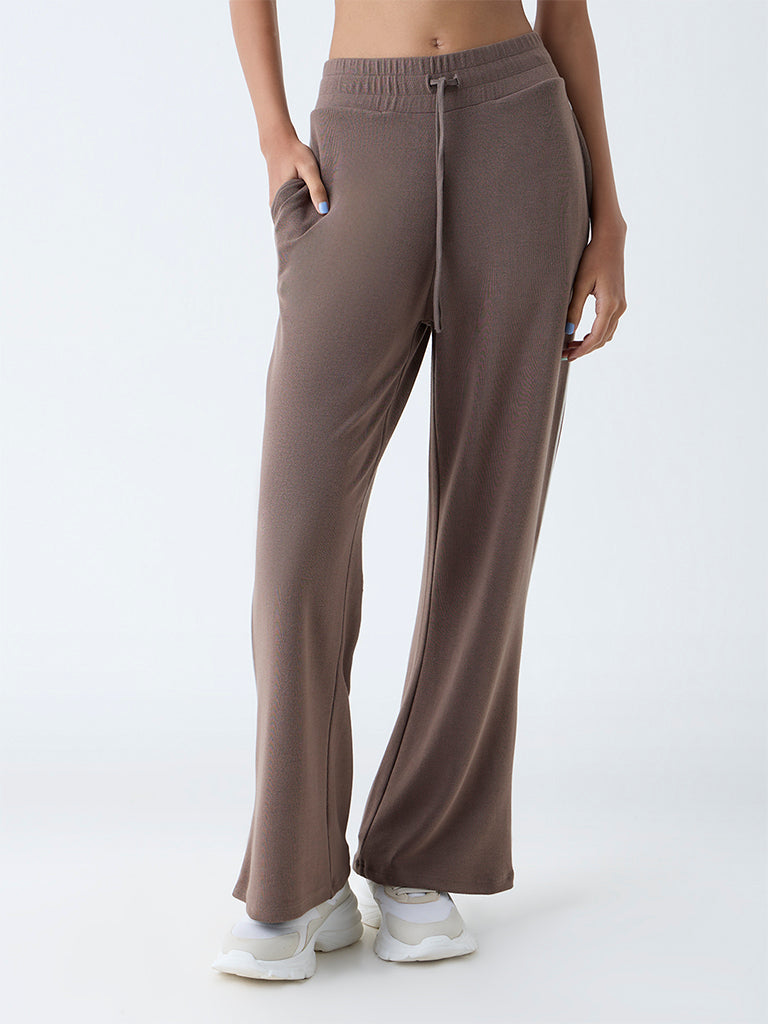 Westside Studiofit Women's Brown Solid High-Rise Track Pants for Sports Wear Front view