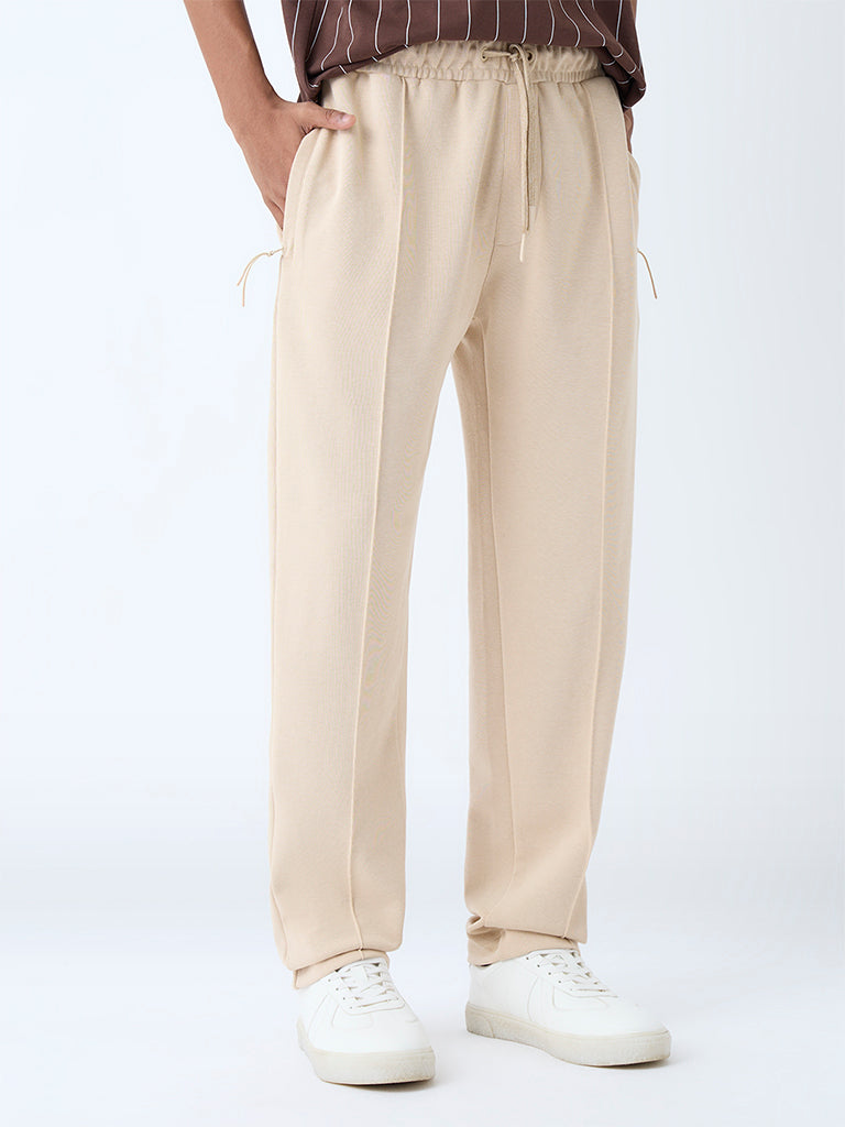 Westside Studiofit Men's Beige Relaxed-Fit Cotton-Blend Track Pants for Sports Wear Front view