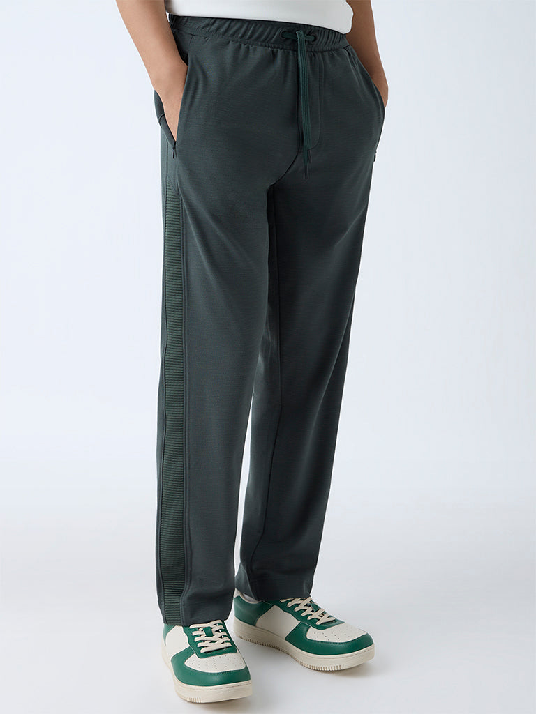 Westside Studiofit Men's Green Relaxed-Fit Mid-Rise Track Pants for Sports Wear Front view