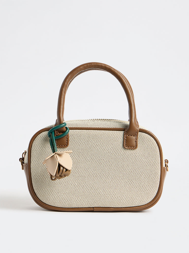 Westside Off-White Textured Sling Bag with a Floral Bag Charm