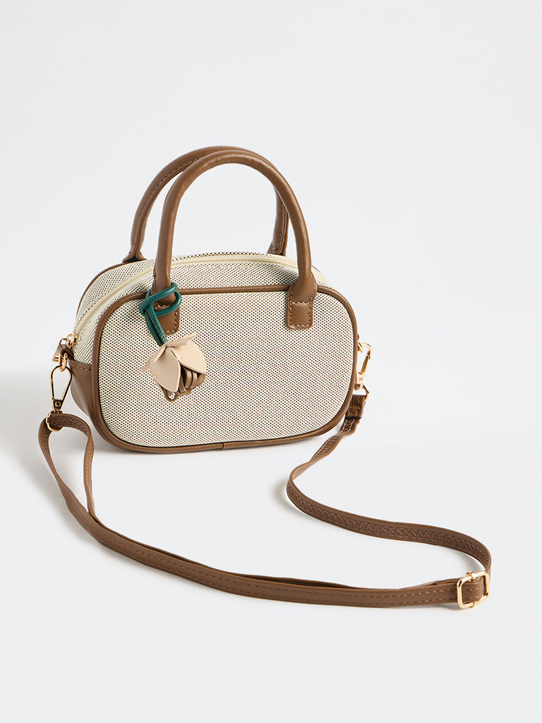 Westside Off-White Textured Sling Bag with a Floral Bag Charm