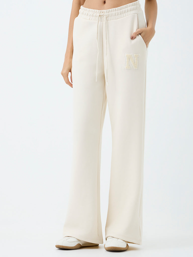 Nuoflexx Off-White Embroidered Flared High-Rise Track Pants