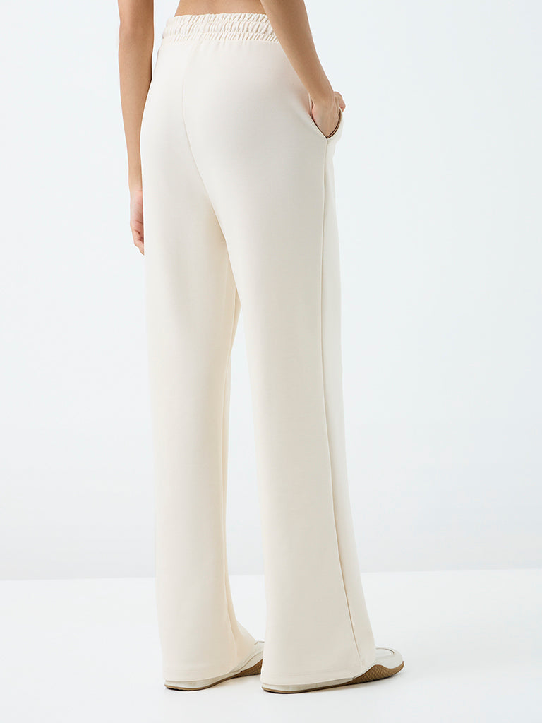 Nuoflexx Off-White Embroidered Flared High-Rise Track Pants