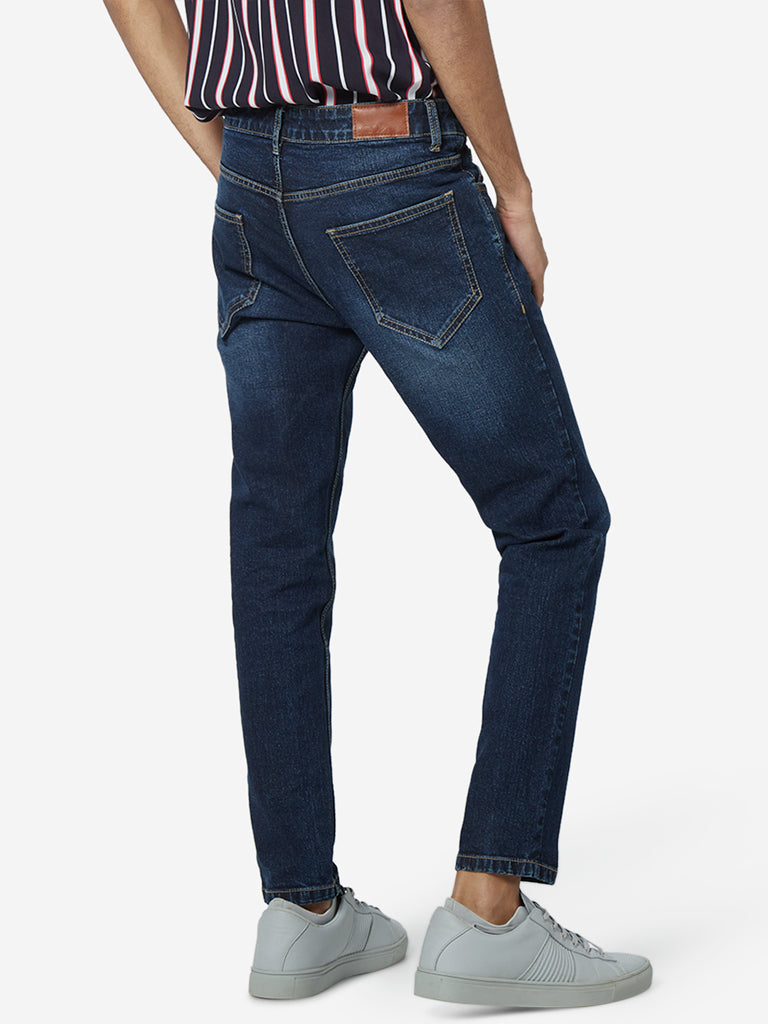 Nuon Blue Whiskering Rodeo Carrot Fit Jeans | Nuon Blue Whiskering Rodeo Carrot Fit Jeans for Men Back View - Westside